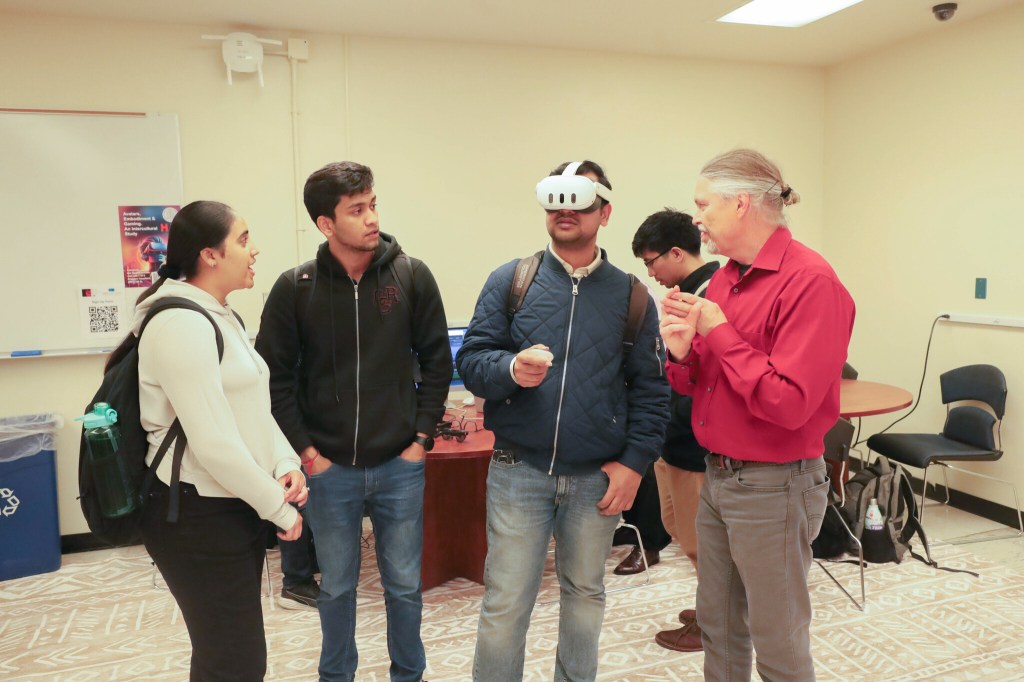 Students trying out VR headsets at the Reality Experience Design lab